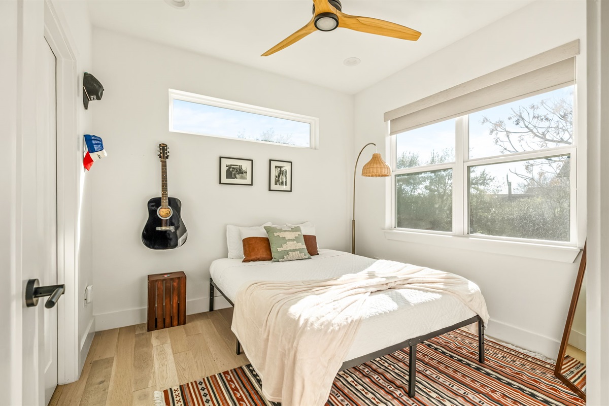 Inviting guest bedroom with a comfortable bed and large windows