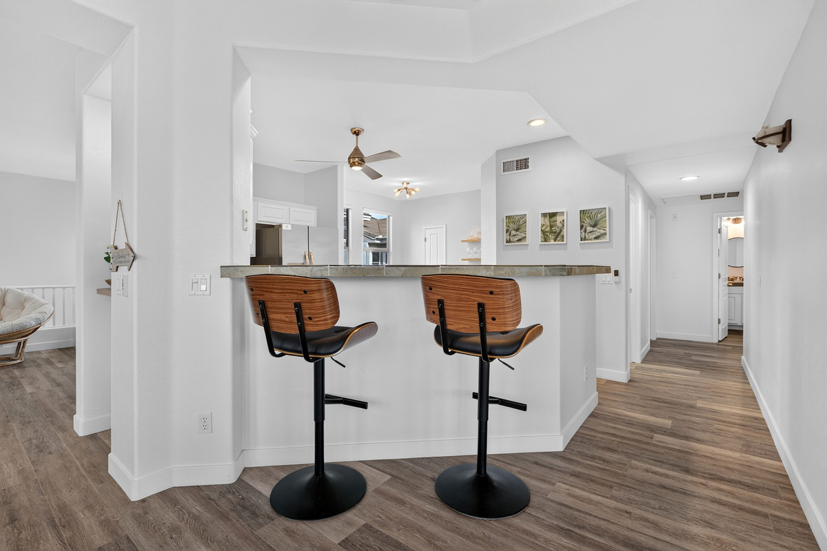 Breakfast bar seating with open kitchen views, natural light, and easy access to the main living spaces.