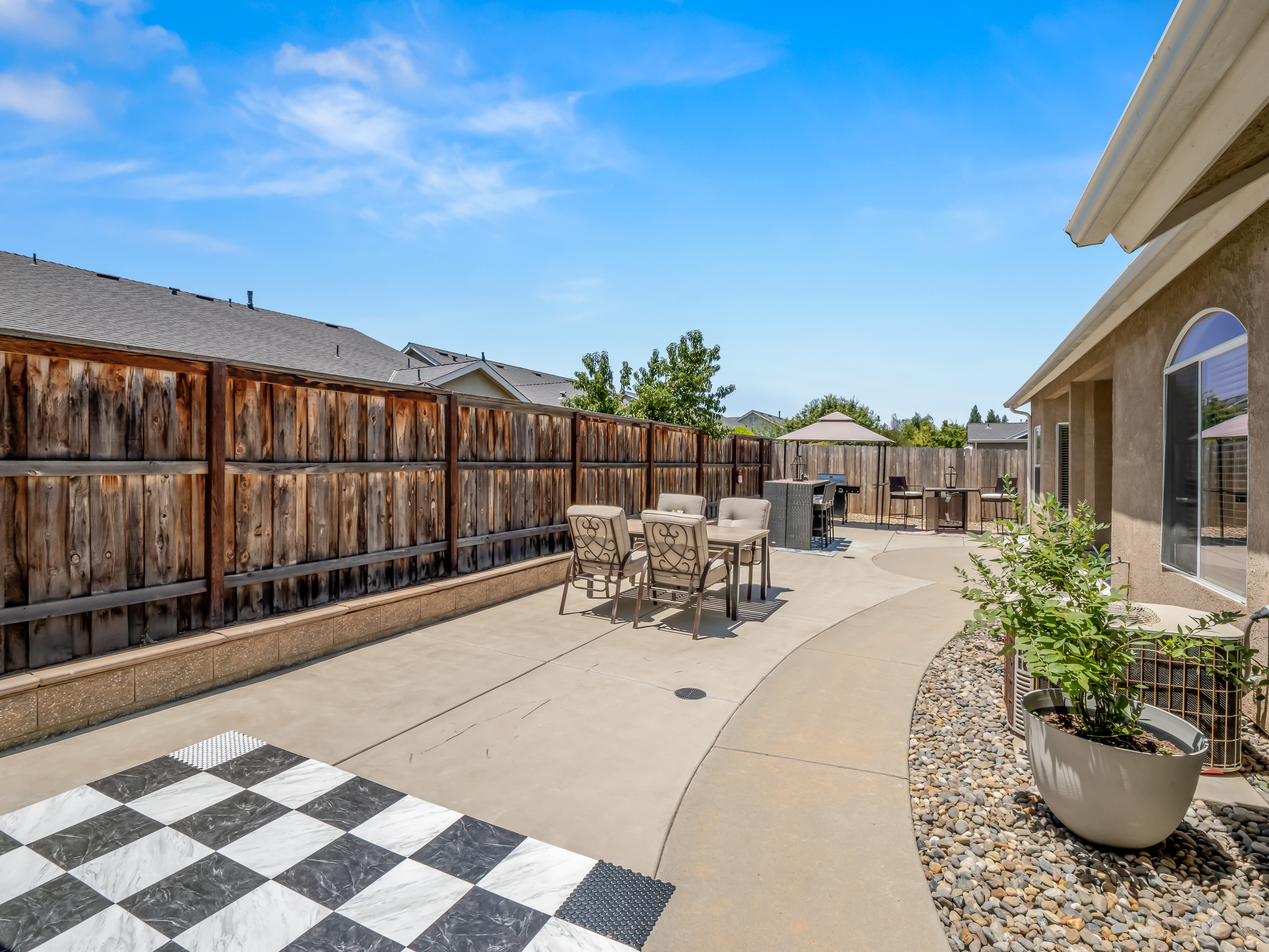Guests of all ages will love this inviting outdoor space, complete with classic oversized games, comfortable seating, and a private setting for enjoying time together.