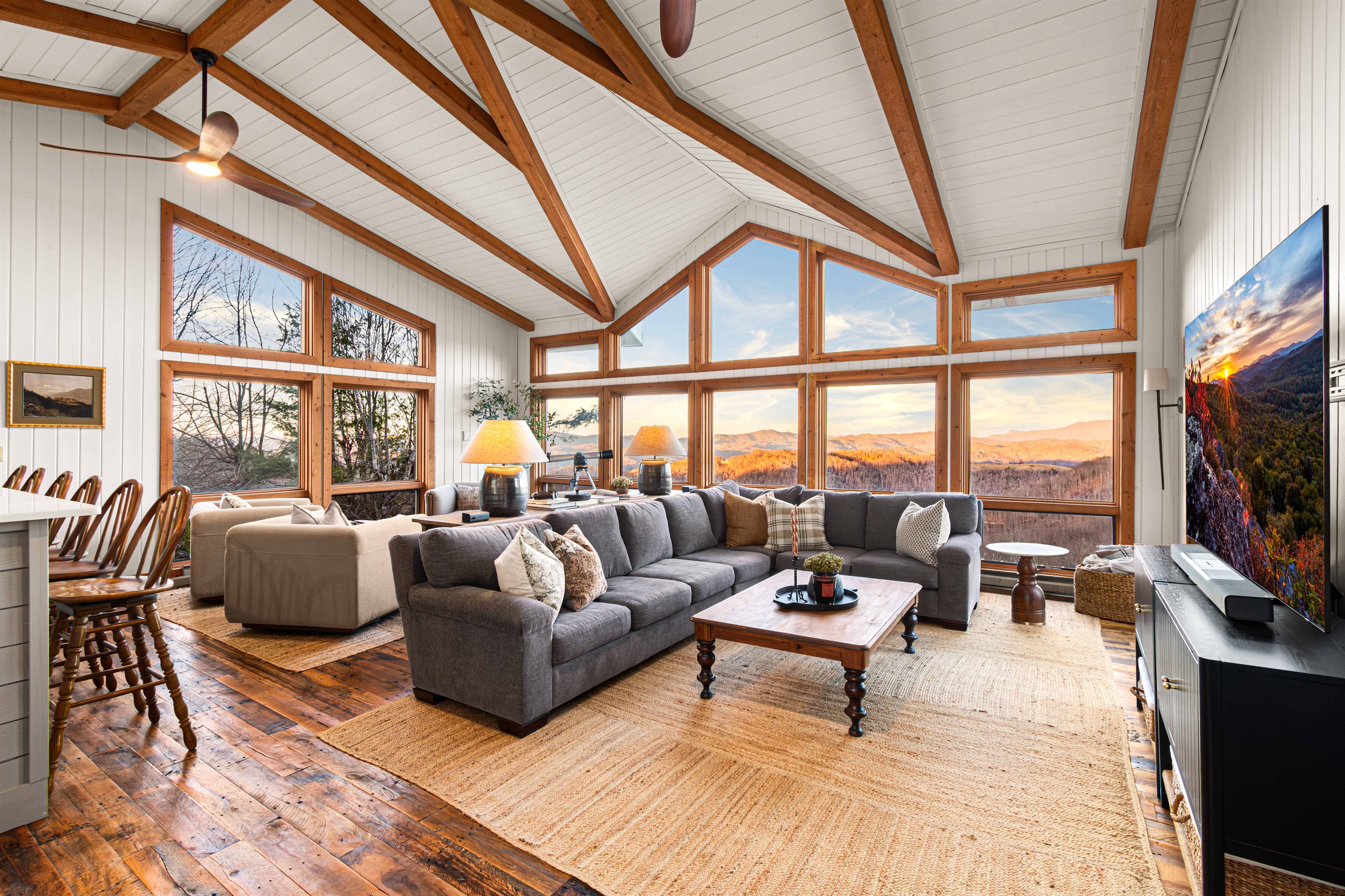 Wide-angle view of the heart of the home with soaring ceilings and panoramic windows.
