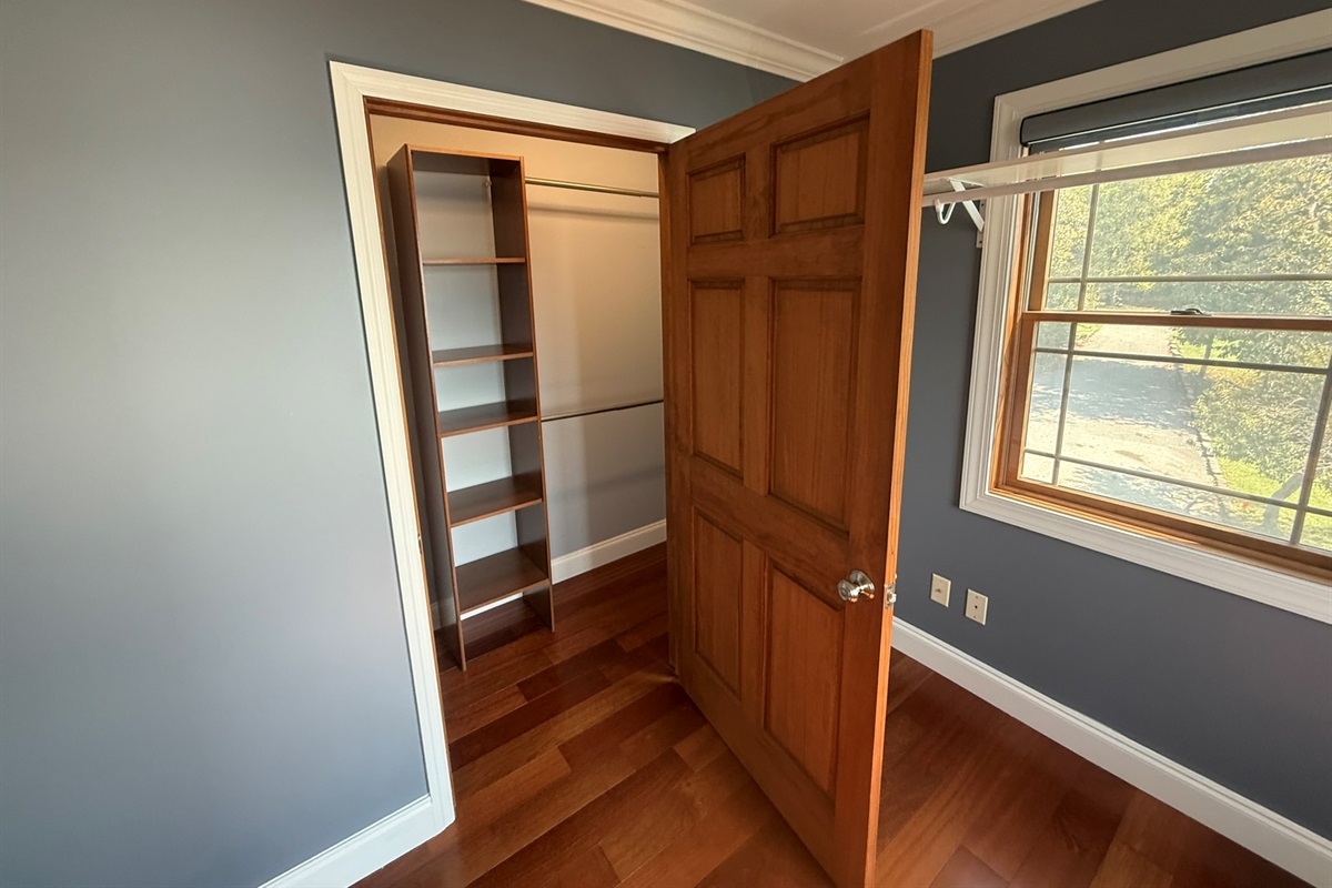 A 2nd closet area and shelving for bedroom 1