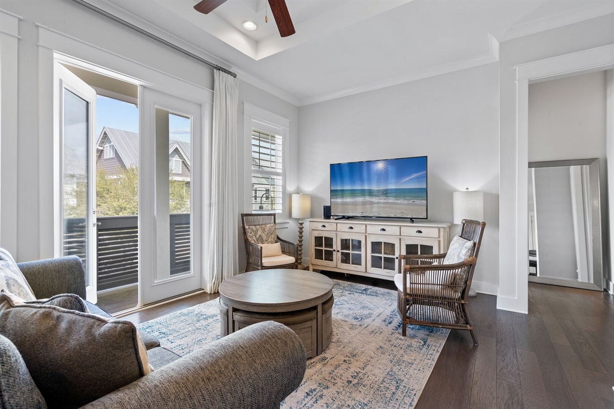 Living area with smart TV and French doors to the balcony.
