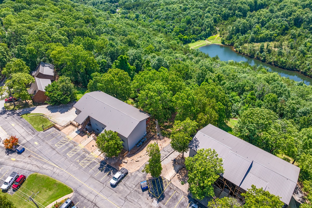 The surrounding woods and pond add to the tucked-away Ozarks atmosphere.