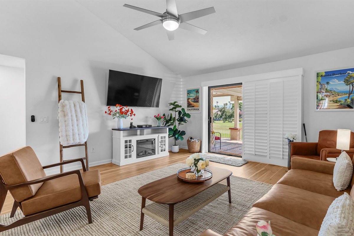 Stylish, sunlit living room with vaulted ceilings