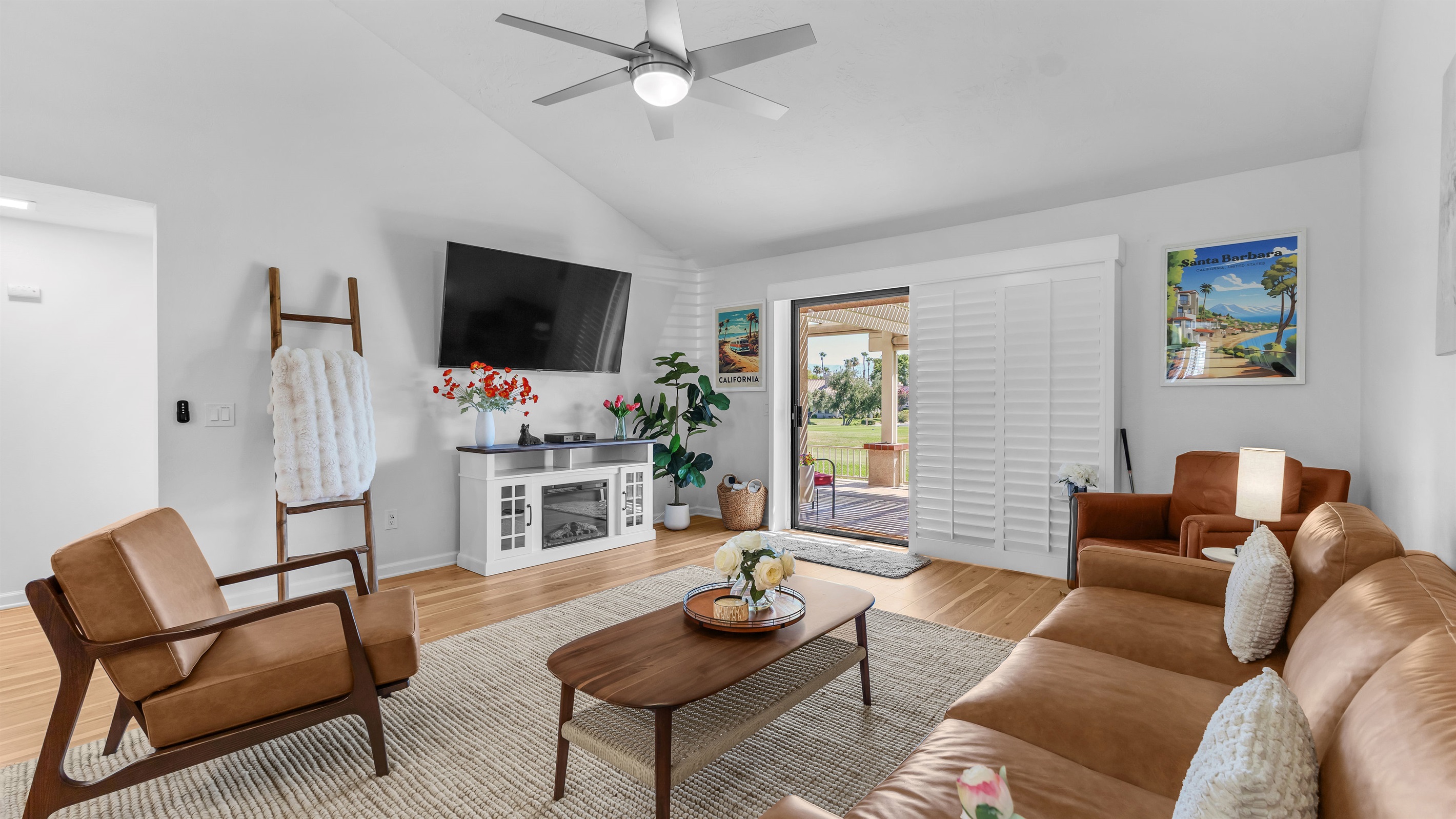 Stylish, sunlit living room with vaulted ceilings