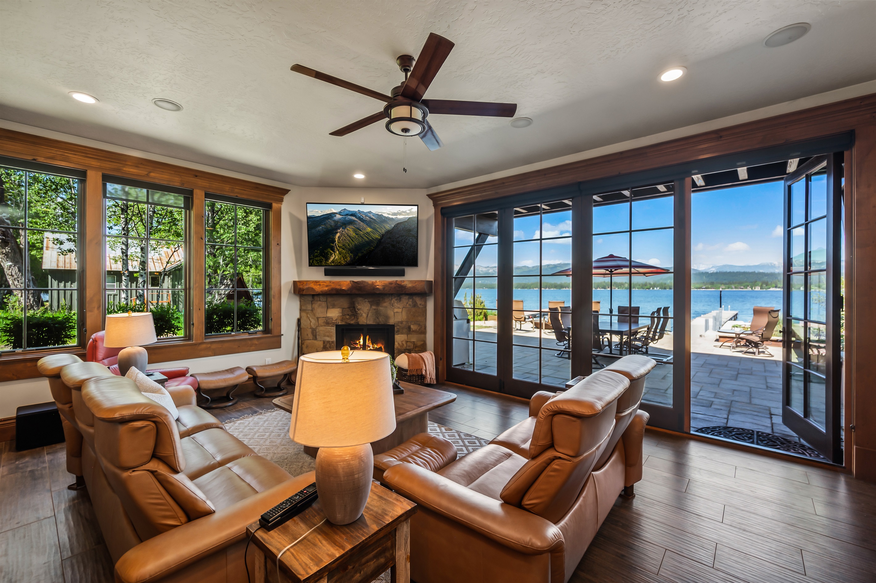 Living Room with TV and Large Glass Doors leading to private lakefront patio