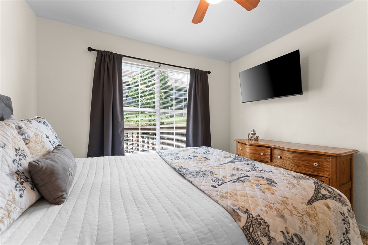 The queen bedroom offers its own TV and a quiet, tucked-away feel for winding down at night.