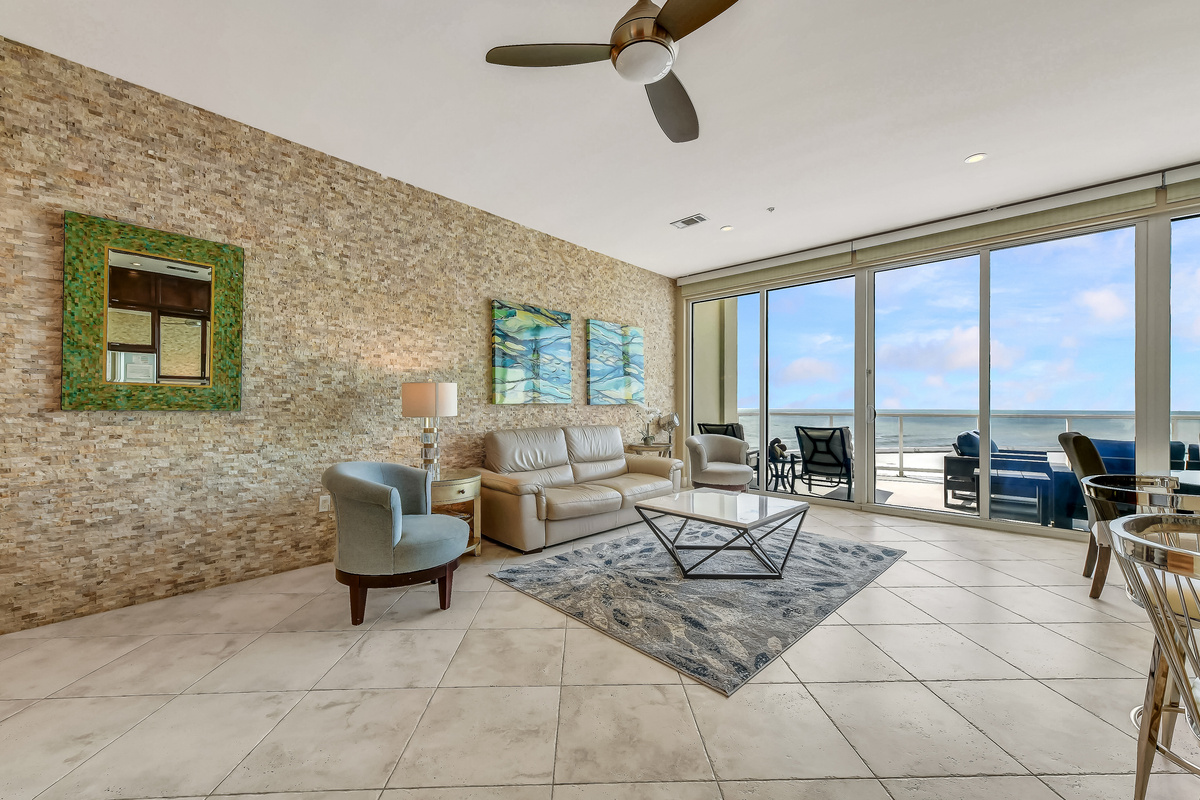 Large 200 sq-ft living area with sleeper sofa, indoor dining, and fully-equipped kitchen with island and granite countertops.  The indoor dining is perfect for bad weather.