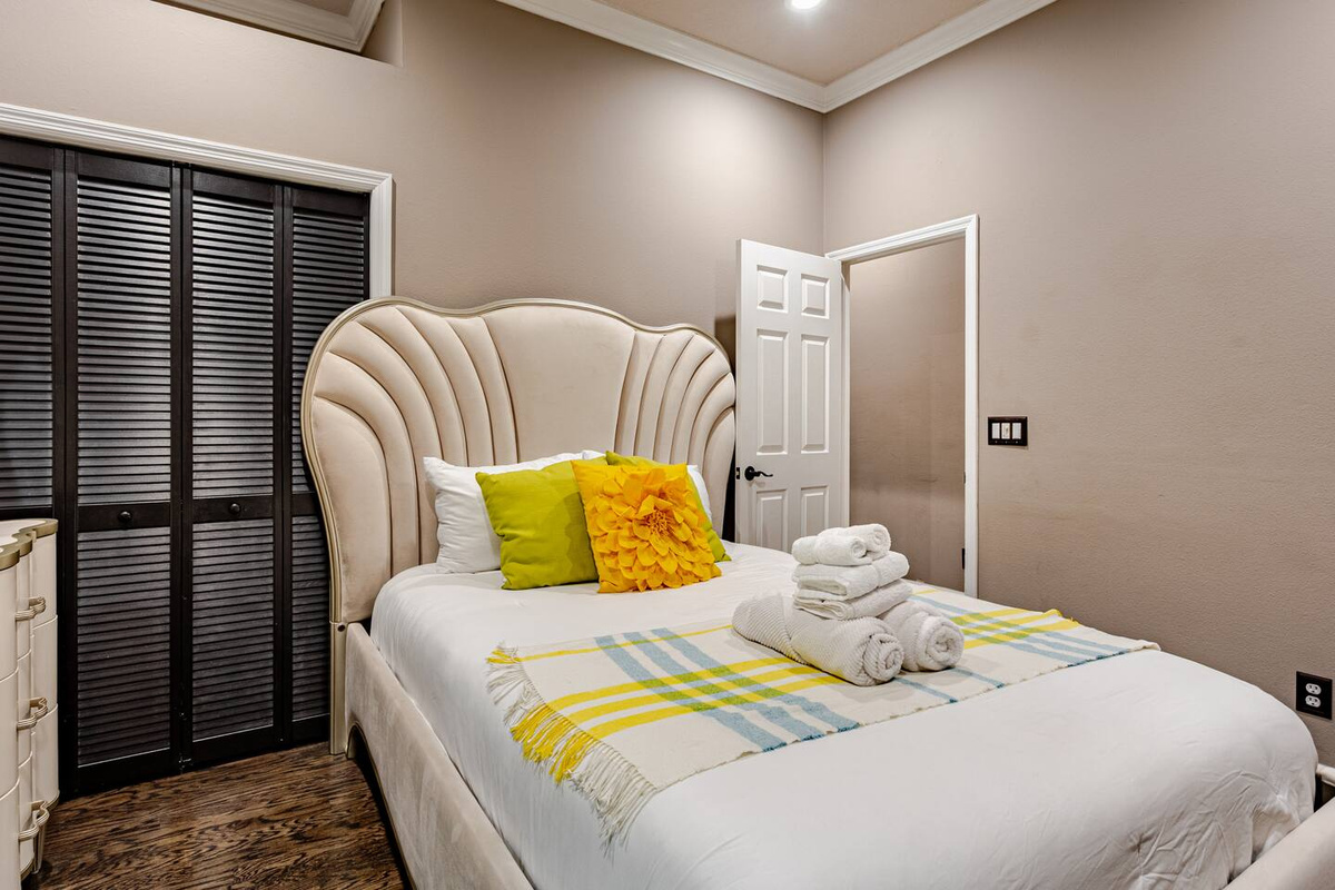 Beautifully appointed guest room featuring elegant furnishings, a plush bed, and a warm, inviting ambiance designed for comfort, relaxation, and a restful stay.
