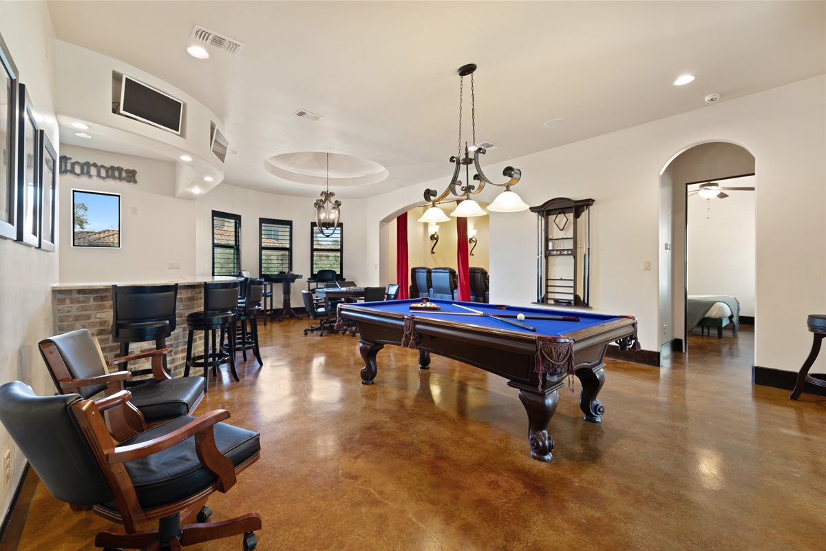 Where fun meets style – the ultimate adult game room, complete with a bar, pool table, poker table, and media room for endless entertainment.