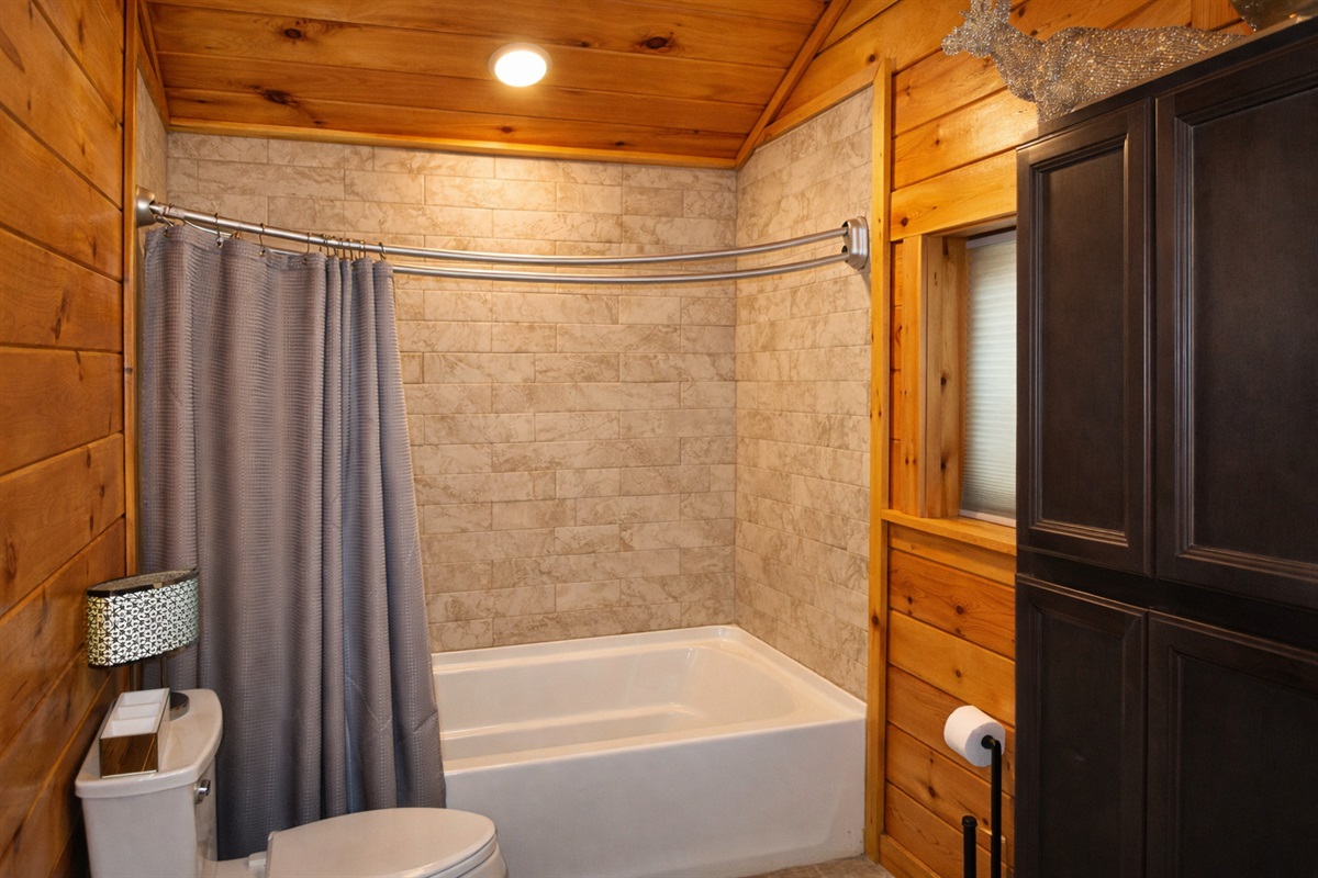 First ensuite bathroom with combination shower and tub.