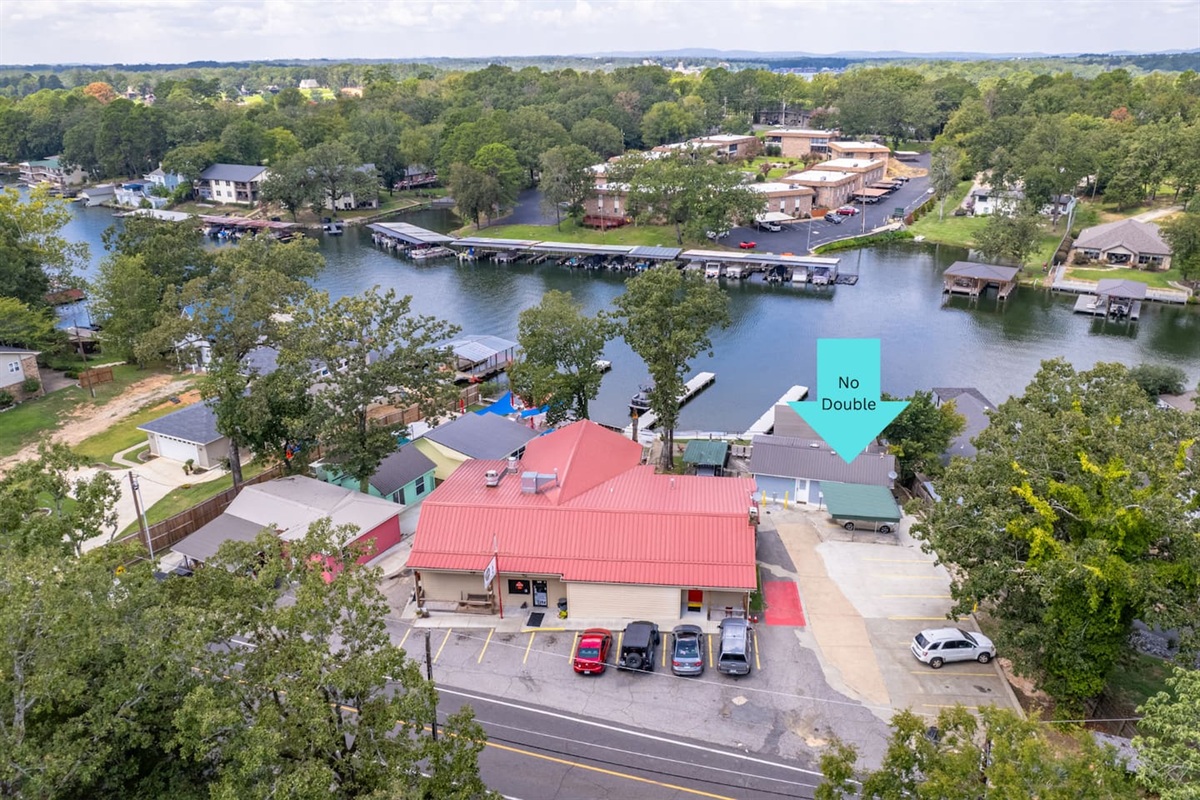 Aerial View: Explore lakefront charm and vibrant nature in scenic Hot Springs!