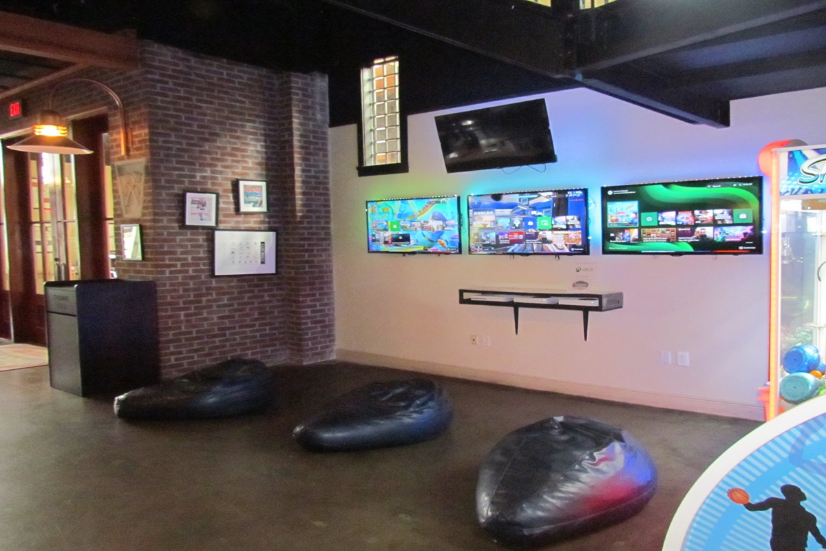 Unleash your inner gamer at the Village Hideaway's vibrant arcade, featuring a wide array of classic and modern games including basketball, shuffleboard, and more, for endless family fun.