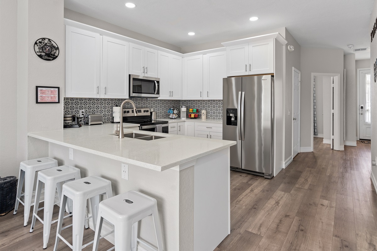 Fully equipped kitchen with large island at Belle’s Villa near Disney