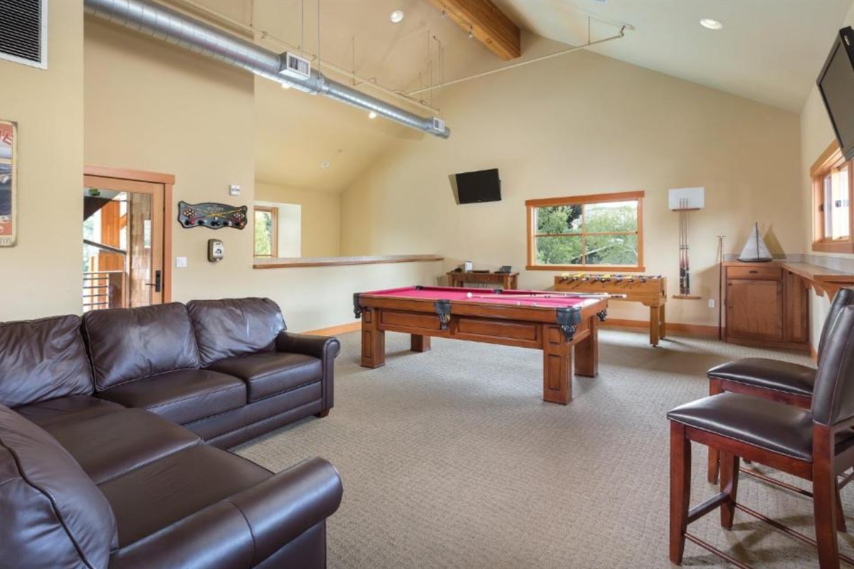 Communal / shared game room with pool table foosball, darts, card table, plus DVD and board games rentals