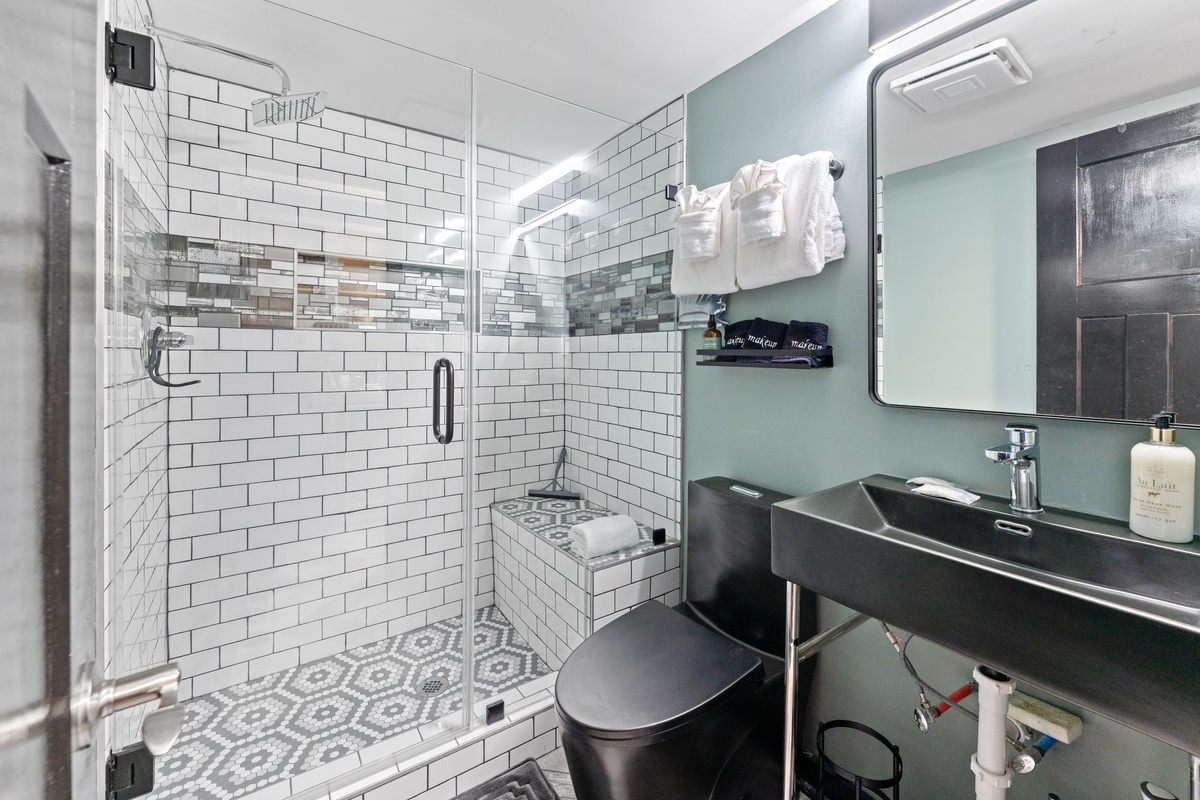 Updated main bathroom with walk-in glass enclosure shower