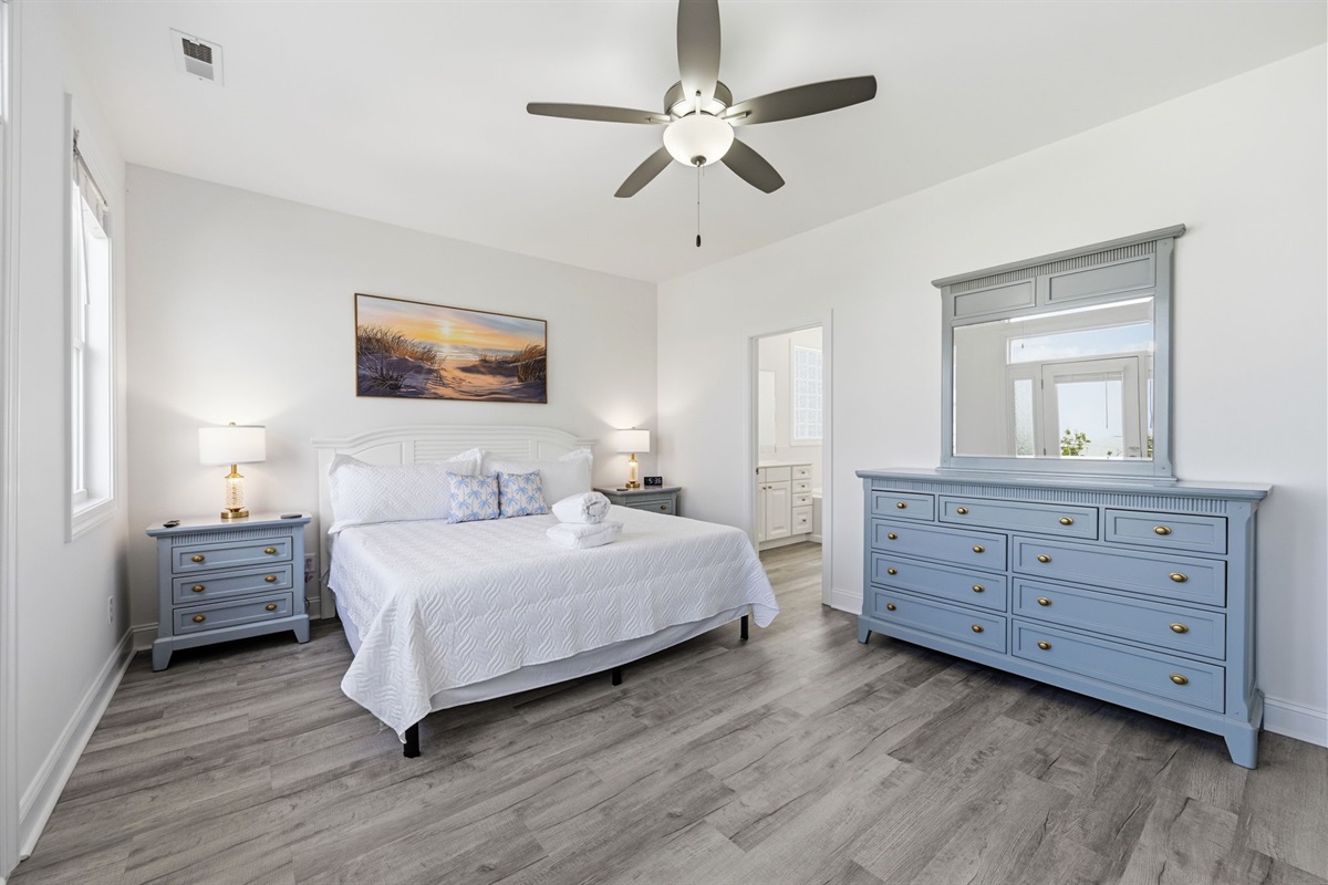 Wake up to coastal comfort in the spacious king master suite with private balcony access
