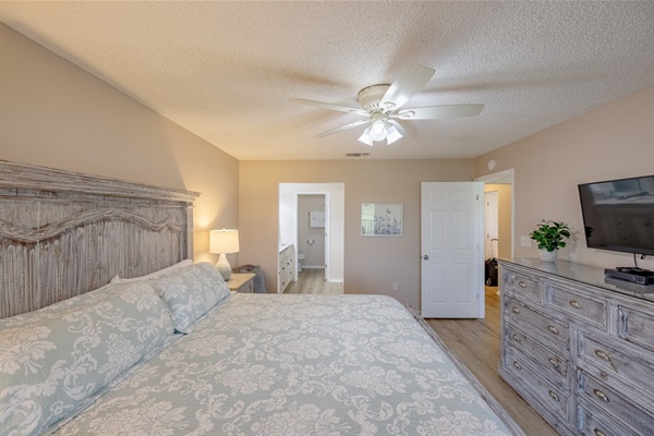 Master bedroom with ceiling fan, ensuite bathroom, smart TT, and clothing storage