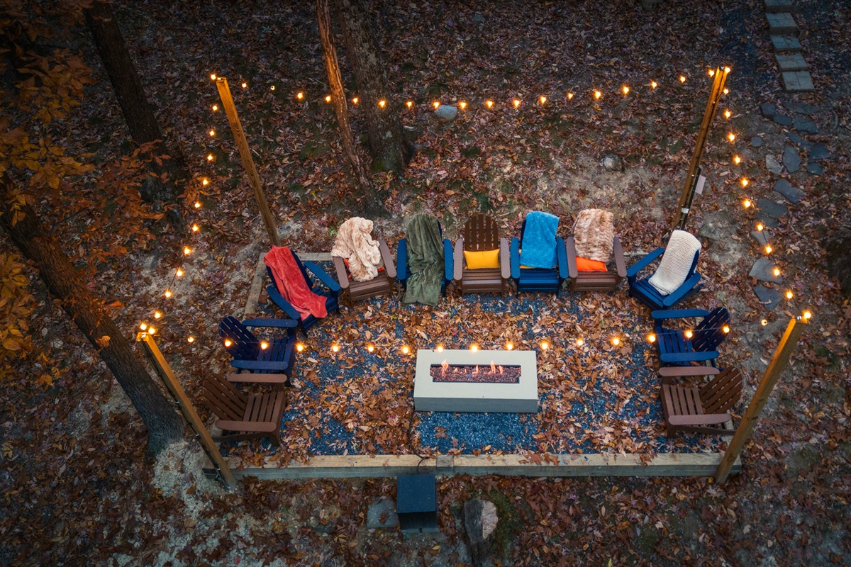 Gather ‘round the fire pit under string lights for s’mores, stories, and stargazing