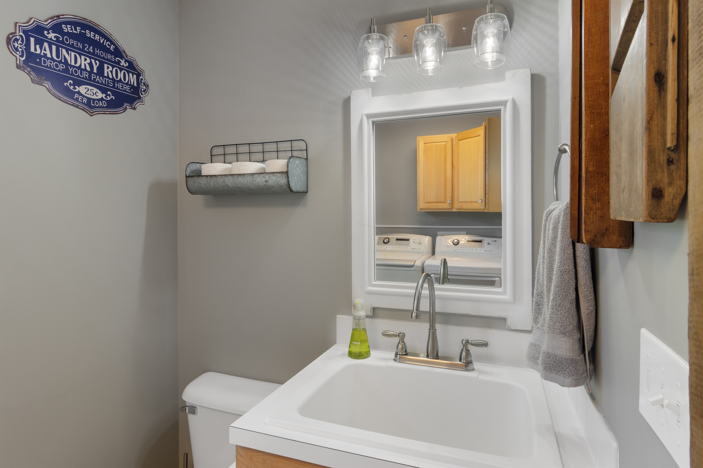 Half bathroom with washer and dryer for guest use.