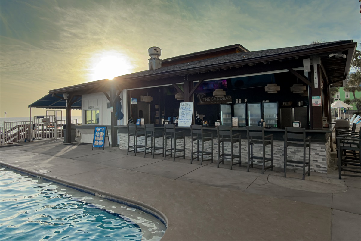 Watch the sunset with a cold drink at The Sandbar. This spot is located just steps from the pool edge. Check the chalkboard for daily drink specials.