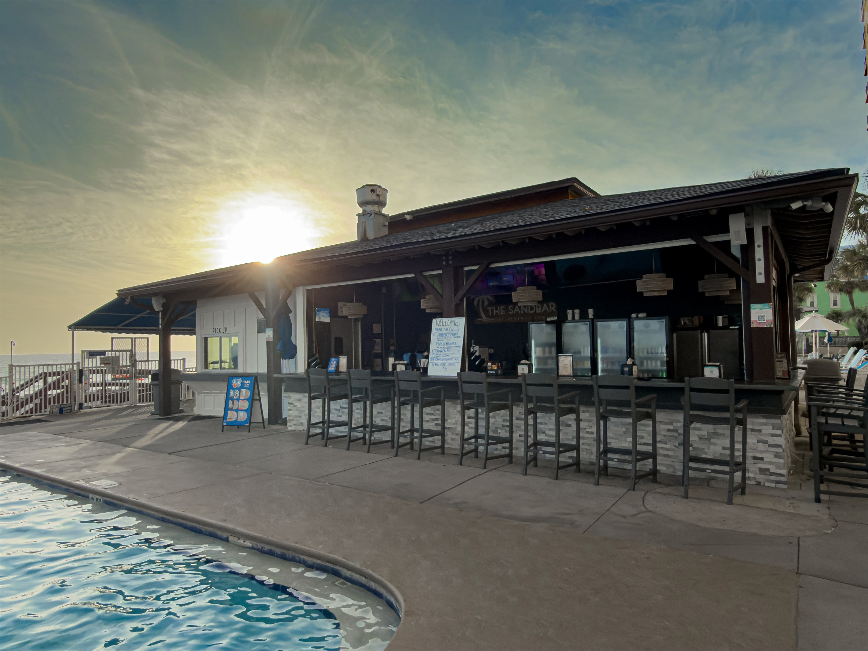 Watch the sunset with a cold drink at The Sandbar. This spot is located just steps from the pool edge. Check the chalkboard for daily drink specials.