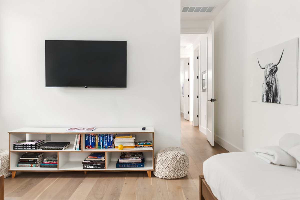 Wall-mounted TV and built-in shelving make this room a cozy retreat.