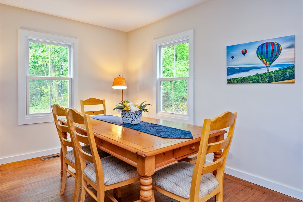 Share meals and memories at a warm wooden dining table, framed by natural light and cheerful décor.
