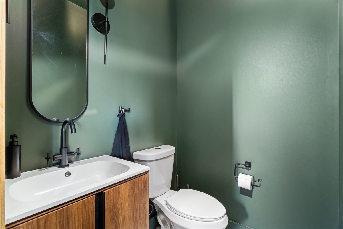 Chic Bathroom Retreat: Enjoy modern design with elegant fixtures and soothing green tones!