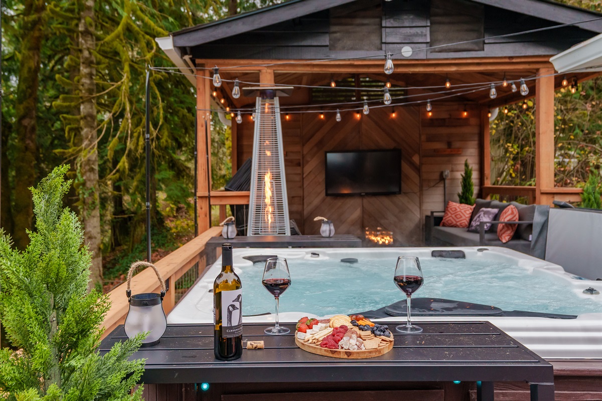 Soak in the hot tub while watching a movie under the covered lounge, complete with fire features and forest views. The perfect spot to relax after exploring Mt. Hood.