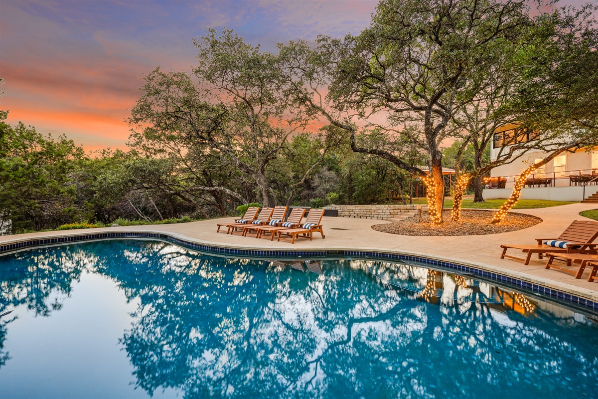 Enjoy the calm of this wooded oasis, where a sparkling pool and soft lighting create a resort-like vibe right in nature’s embrace.