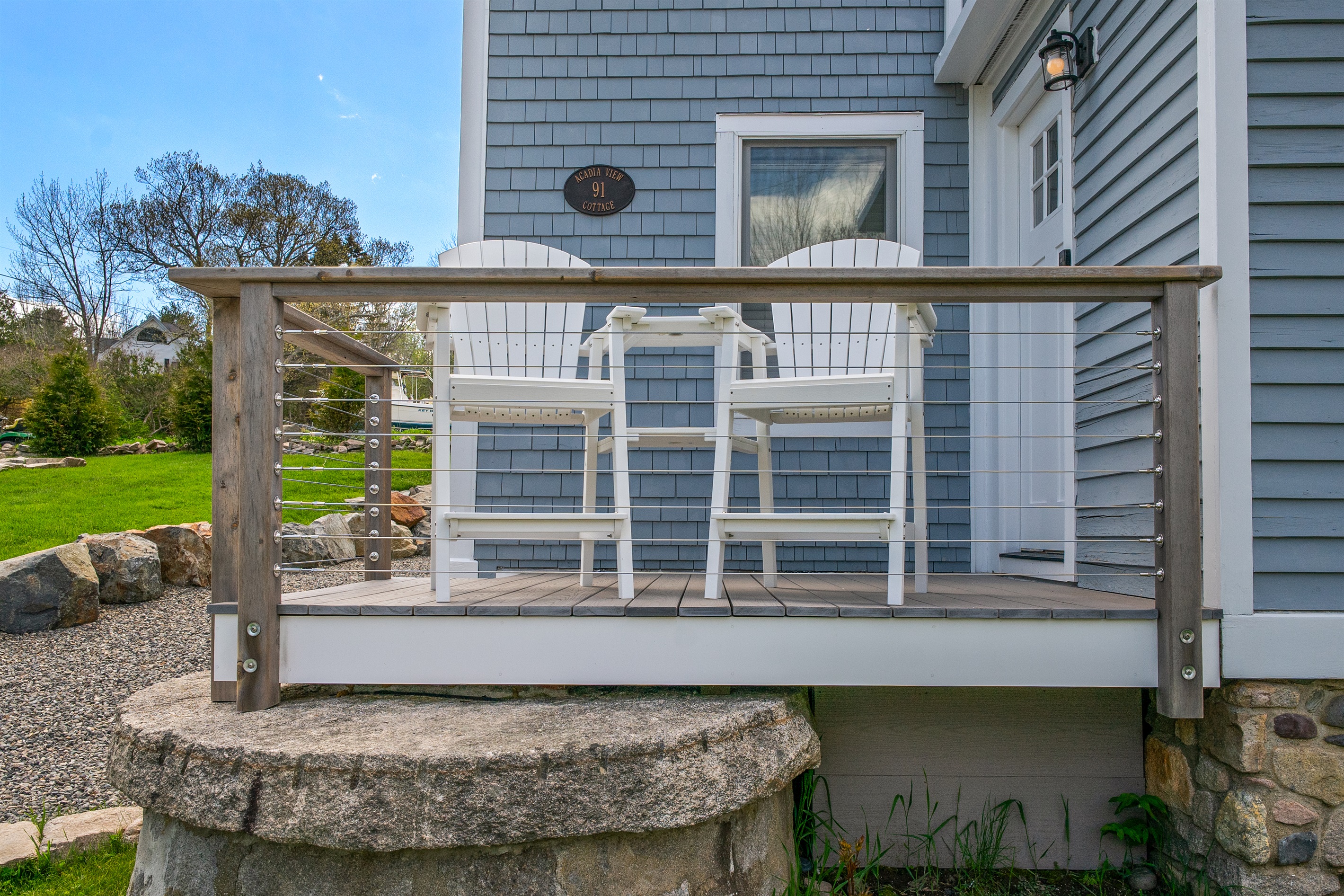 Your morning coffee station. This entry deck features new Adirondack-style seating, perfect for soaking in the sounds of historic Hall Quarry. Breathe in the salt air and plan your day on the Quiet Side from this peaceful village basecamp.