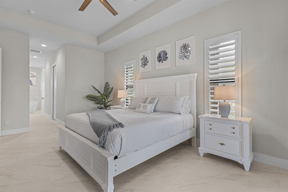 Relax in the primary suite featuring a king-size bed adorned with plush bedding and a luxurious ensuite bathroom, offering the perfect sanctuary for your getaway!