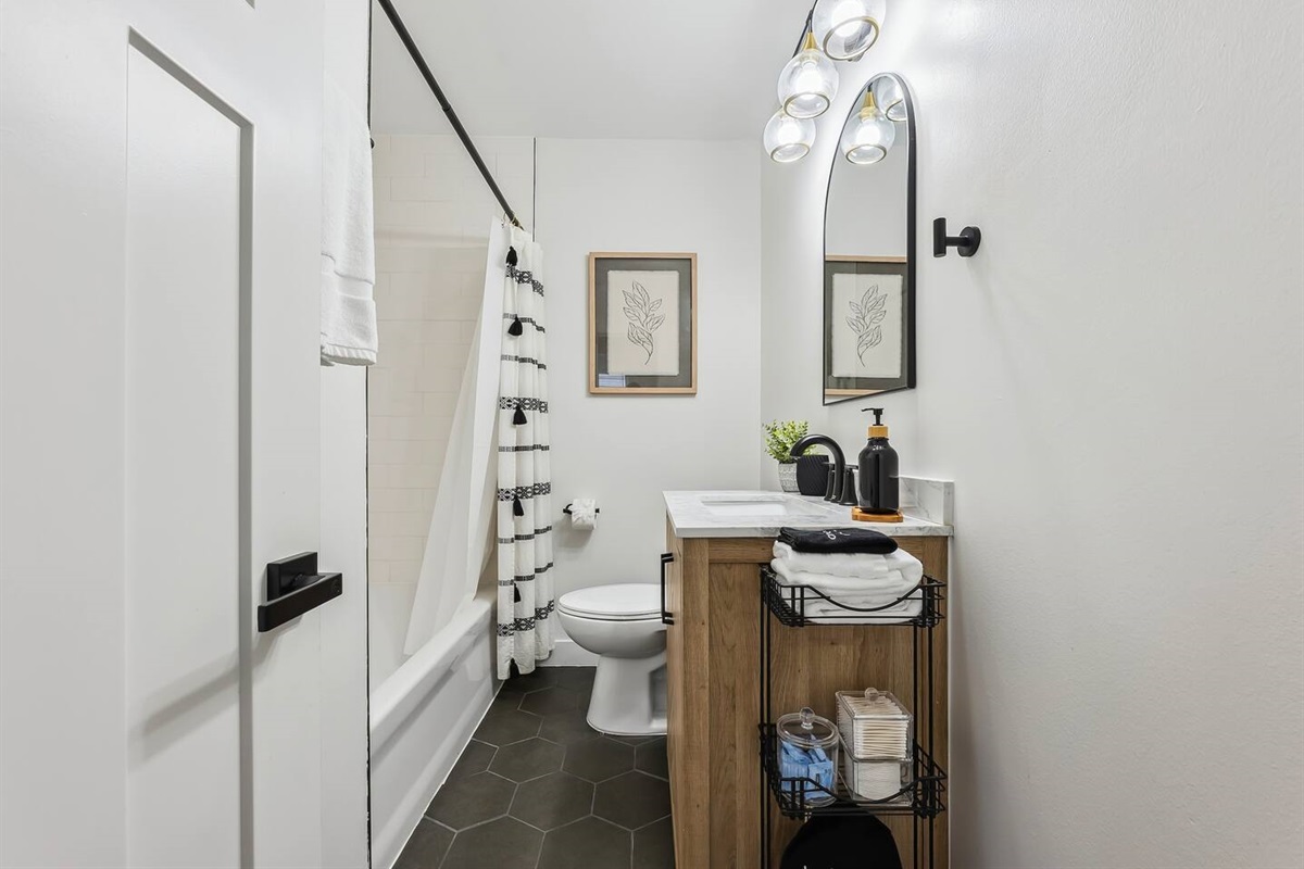 This bathroom features a tile tub/shower combination.