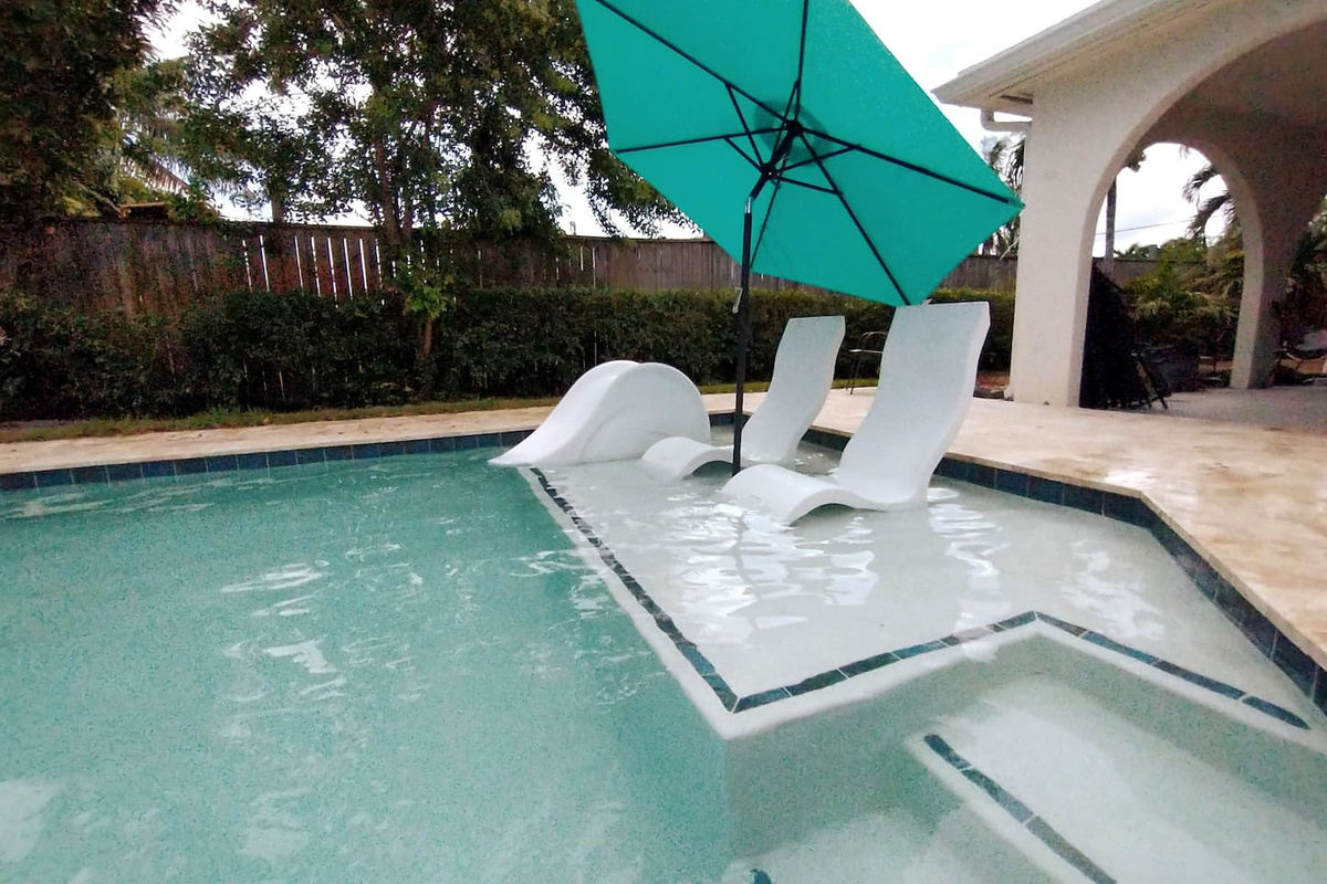 Tannng shelf with loungers,kiddie slide and adjustable umbrella