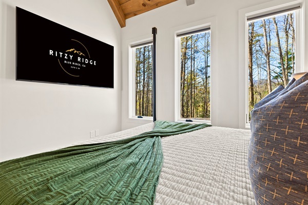Cozy up in this tranquil bedroom where comfort meets the calm of the forest, complete with plush pillows and a warm palette.