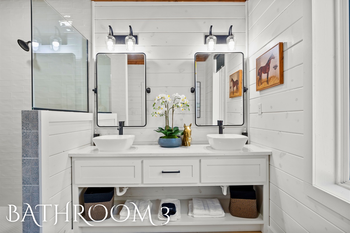 A crisp and clean ensuite featuring soft lighting, a spacious vanity, and plenty of room to unwind.