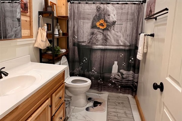 There are five bathrooms at Mama Bear Cabin.  This bathroom, with a tub and shower, is on the main floor next to The Great Room with easy access to the hottub.