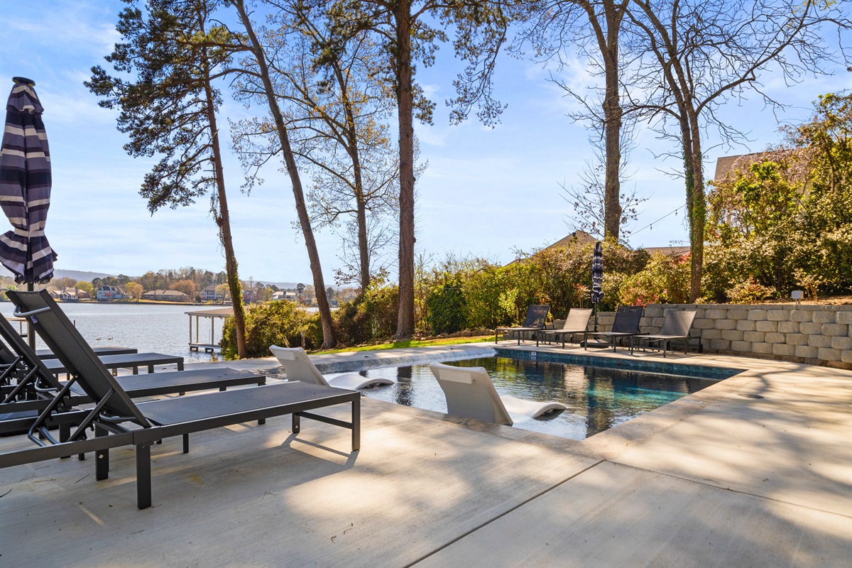Lounge by the pool with plenty of space to stretch out, soak up the sun, and take in the serene waterfront scenery all around you.