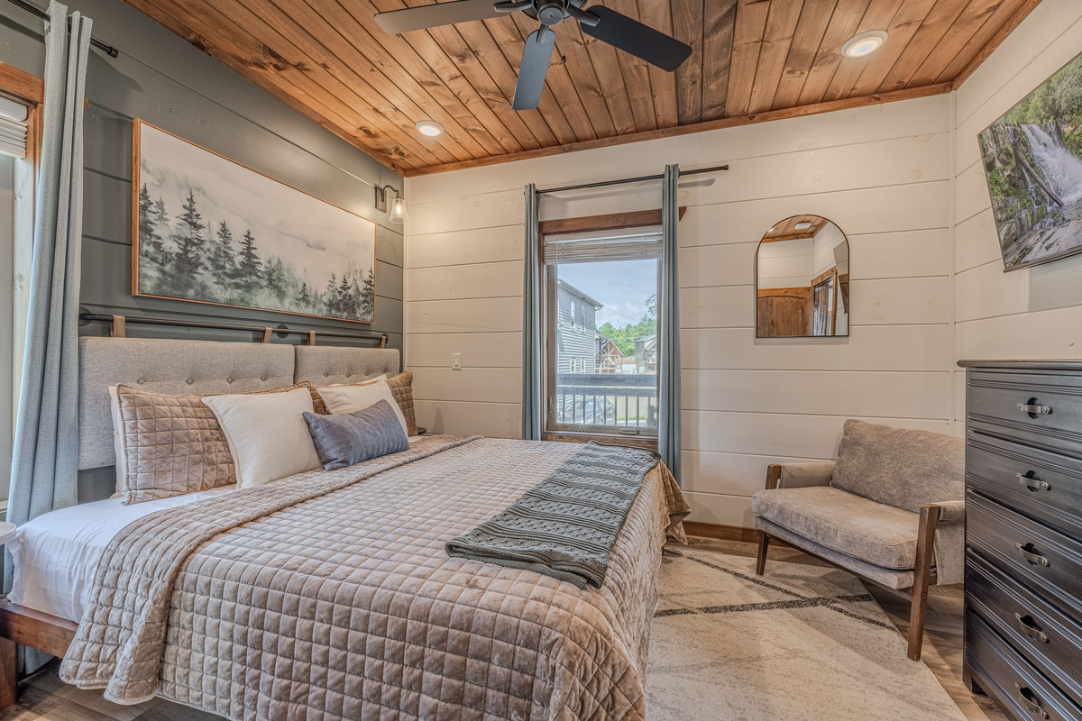 Second king bedroom with comfortable furnishings and a calm cabin feel.