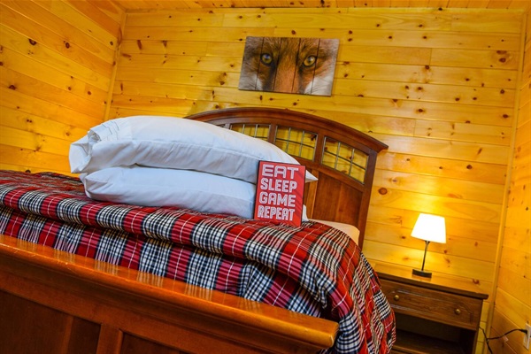 A queen-sized bed is in THE FOX’S DEN