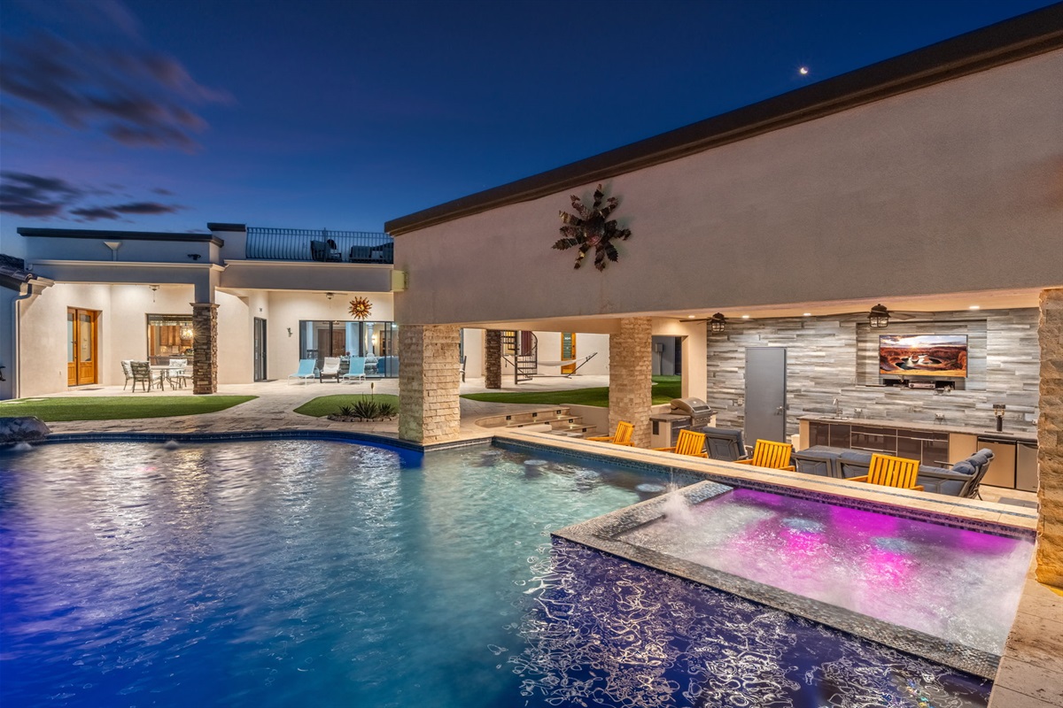 Evening poolside glow creates a private resort atmosphere perfect for late-night swims and relaxing under the stars