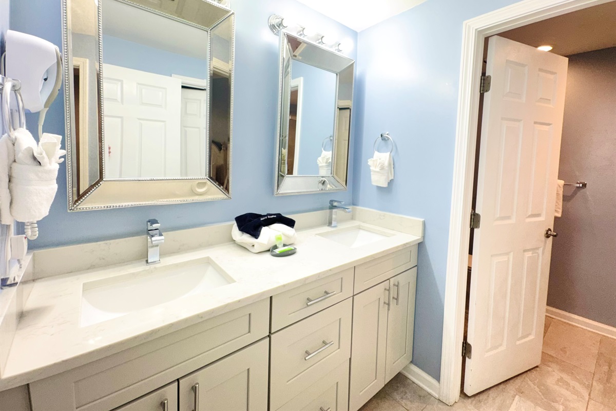 Double sink vanity, and tiled shower in master bath