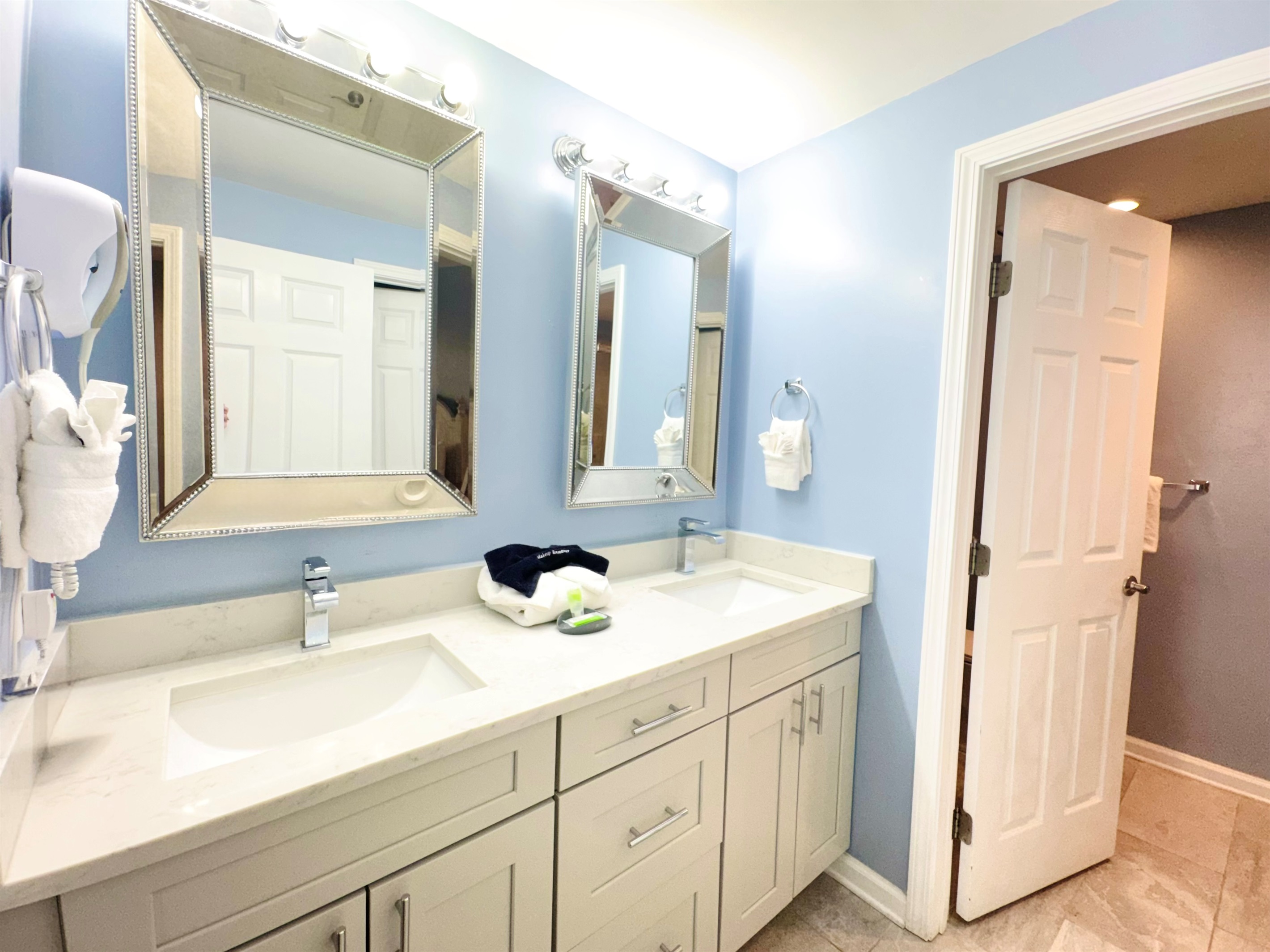 Double sink vanity, and tiled shower in master bath