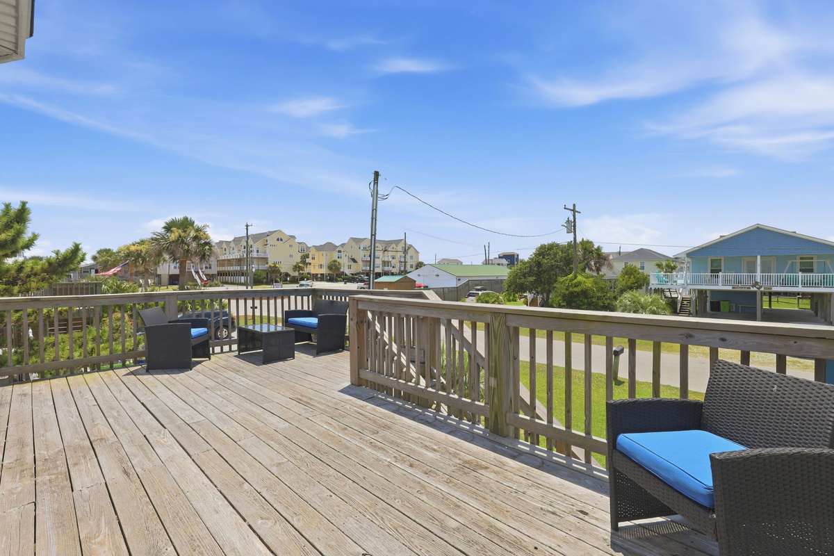 Spacious wraparound deck with comfortable seating, perfect for morning coffee or evening relaxation