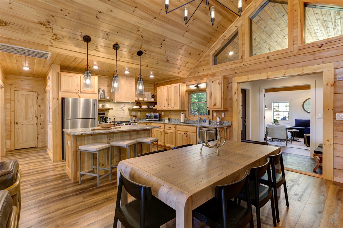 Enjoy meals around the farmhouse table, sip coffee at the island, and make memories in this beautifully designed cabin kitchen.