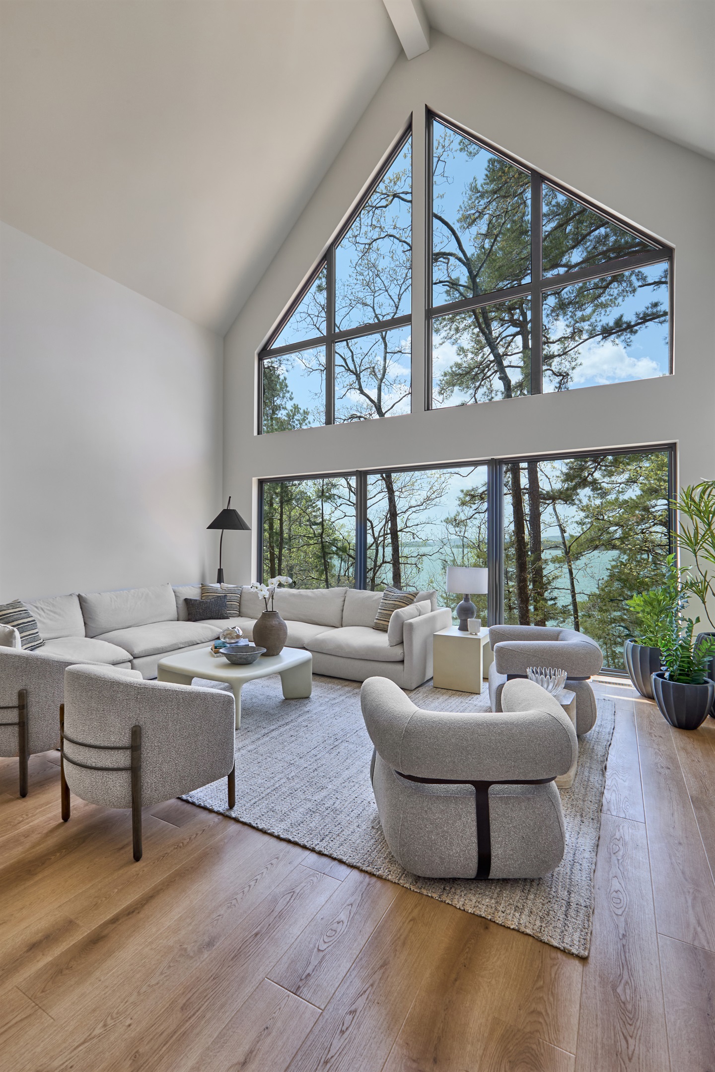 Take in panoramic lake views from the airy, vaulted living room with floor-to-ceiling windows and cozy, modern furnishings.