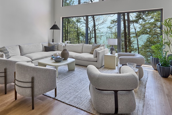 Take in panoramic lake views from the airy, vaulted living room with floor-to-ceiling windows and cozy, modern furnishings.