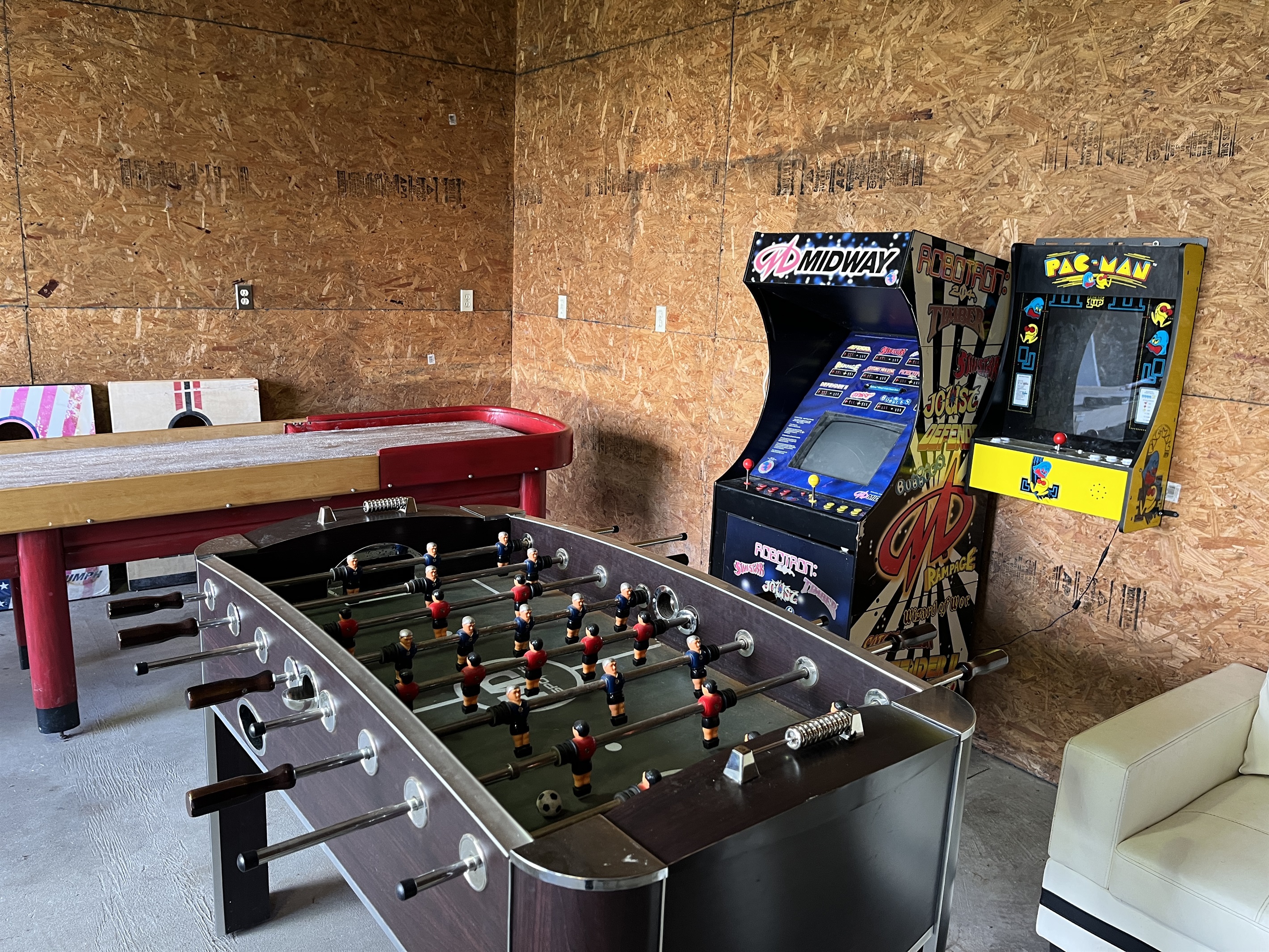 Roundtripper game room includes a custom shuffle board, foosball table and more!