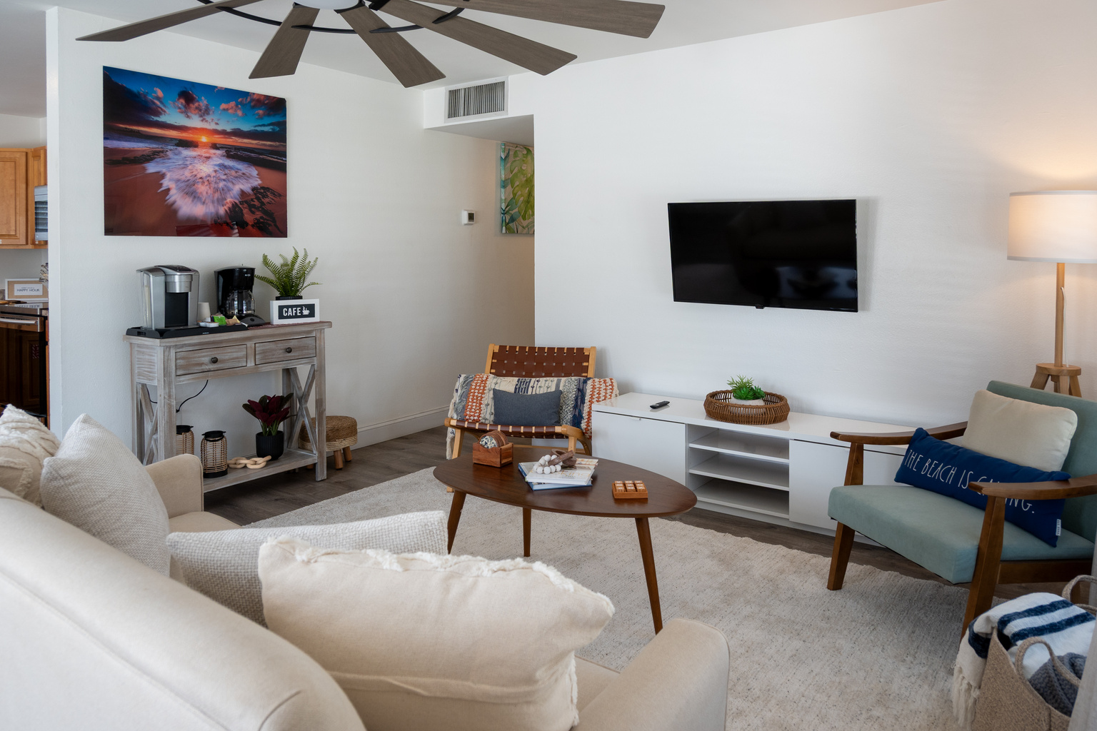 Living room with Smart TV, coffee bar and comfy chairs